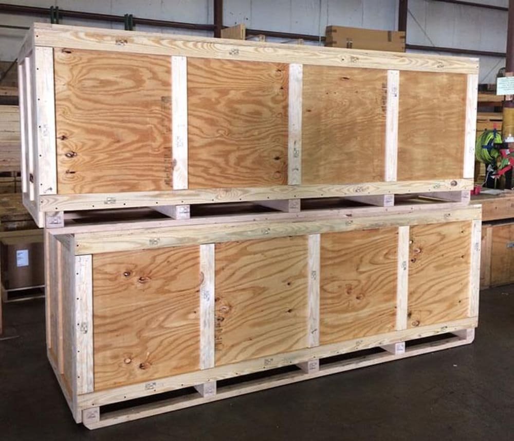 Two large stacked wooden crates in a warehouse