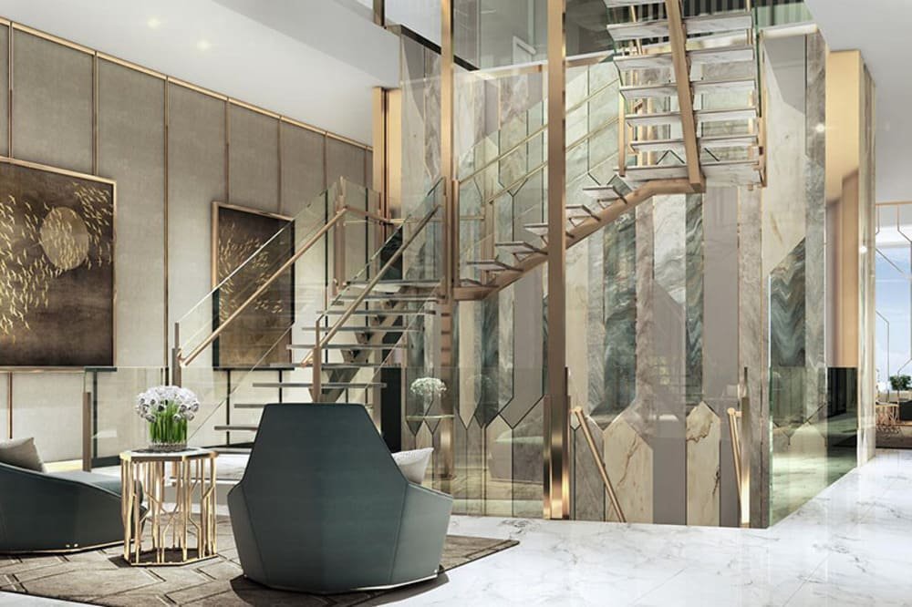 A modern lobby with a glass staircase, marble walls, abstract paintings, and geometric chairs