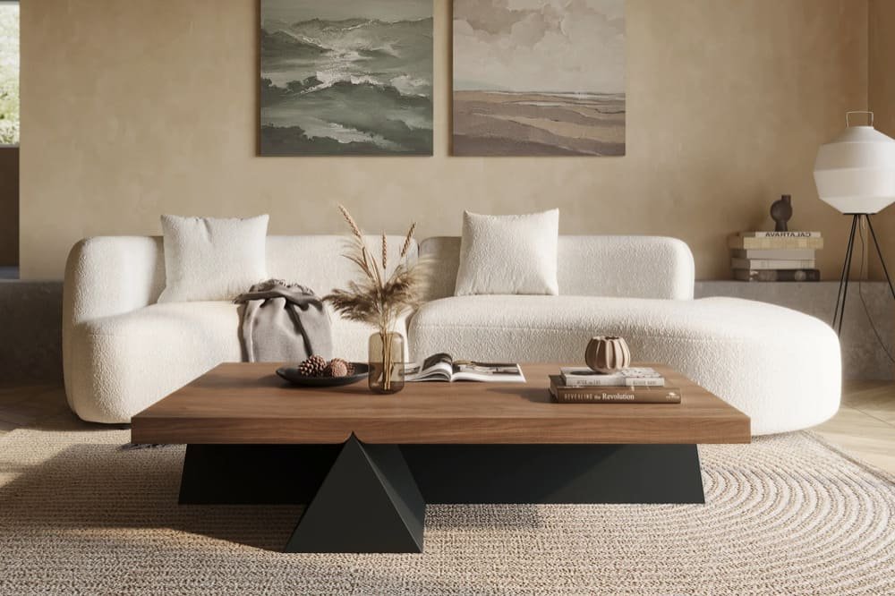 A modern living room with a curved white sofa, wooden coffee table, abstract paintings, and a decorative floor lamp
