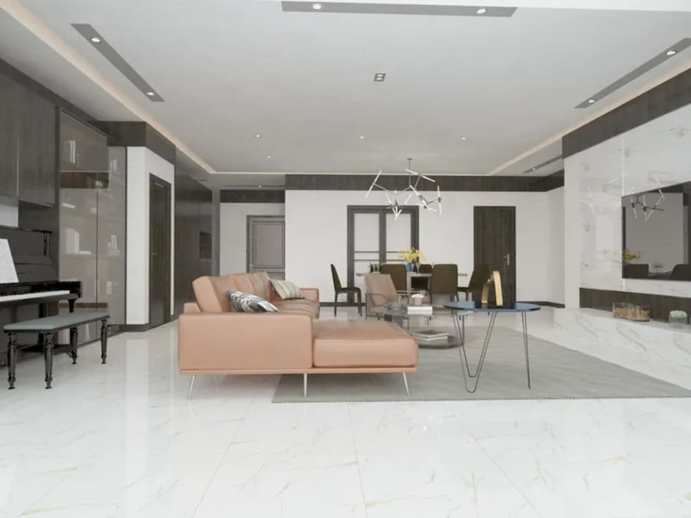 Modern living room with light brown sectional sofa, black piano, white porcelain tile and geometric chandeliers