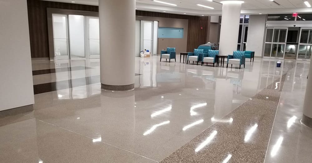 Apartment lobby seating area with glossy marble floors and floor-to-ceiling windows