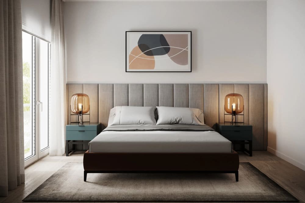 Modern bedroom with upholstered headboard and teal nightstands with warm lamps
